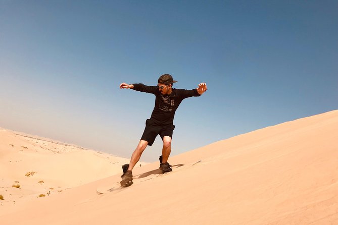 Abu Dhabi Morning Desert Safari,Dune Bashing,Sandboarding,Camel Riding&Quad Bike - Sandboarding down the dunes