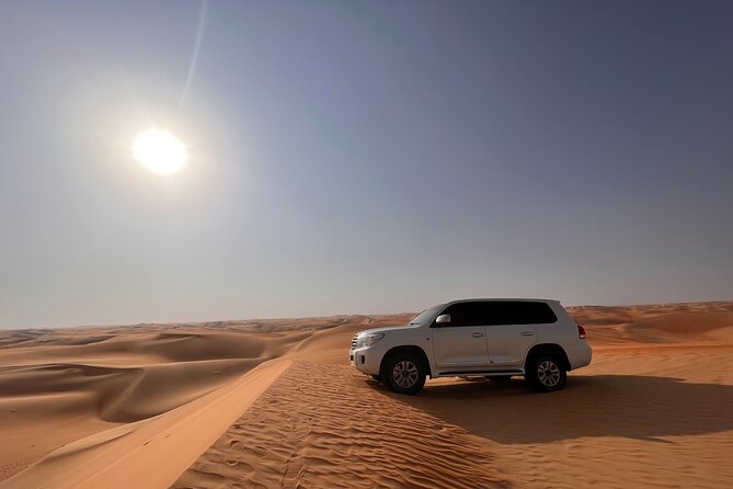 Desert Safari with Dune Bashing and Camel Ride plus Sand Boarding - A sunset stop made for photographs