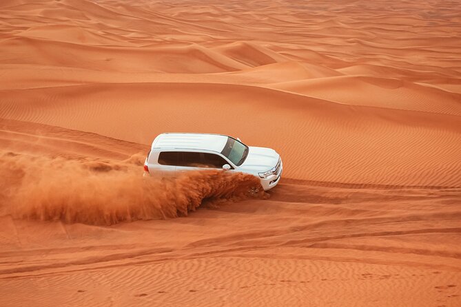 Dubai Desert Safari, Dune Bashing, Camel Ride, Sandboarding & BBQ - Dune bashing across Lahbab’s red sand