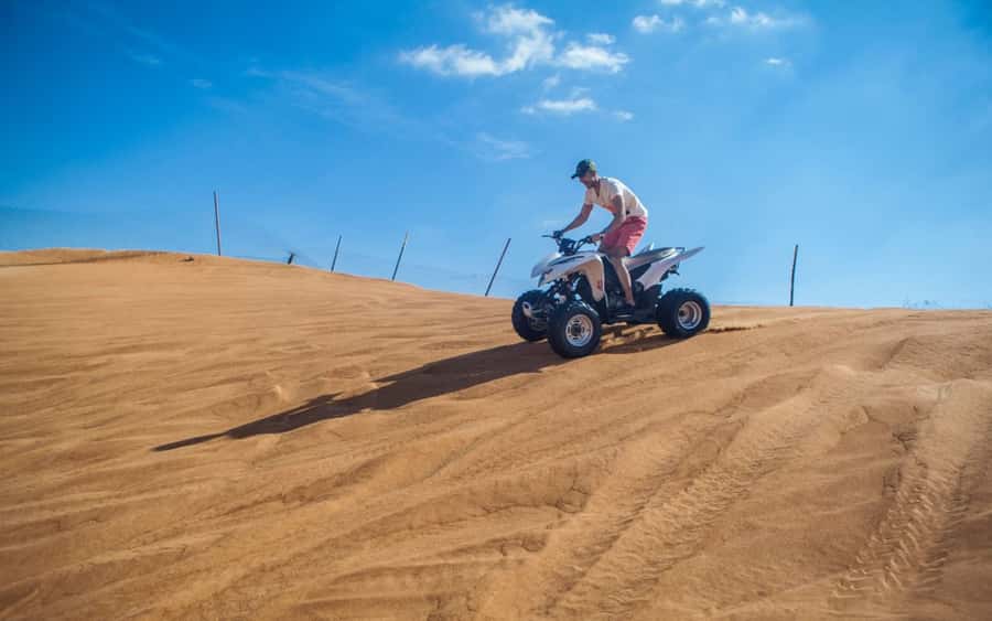 Dubai: Desert Safari, Quad Bike, Camel Ride and Sandboarding - Sandboarding above the desert
