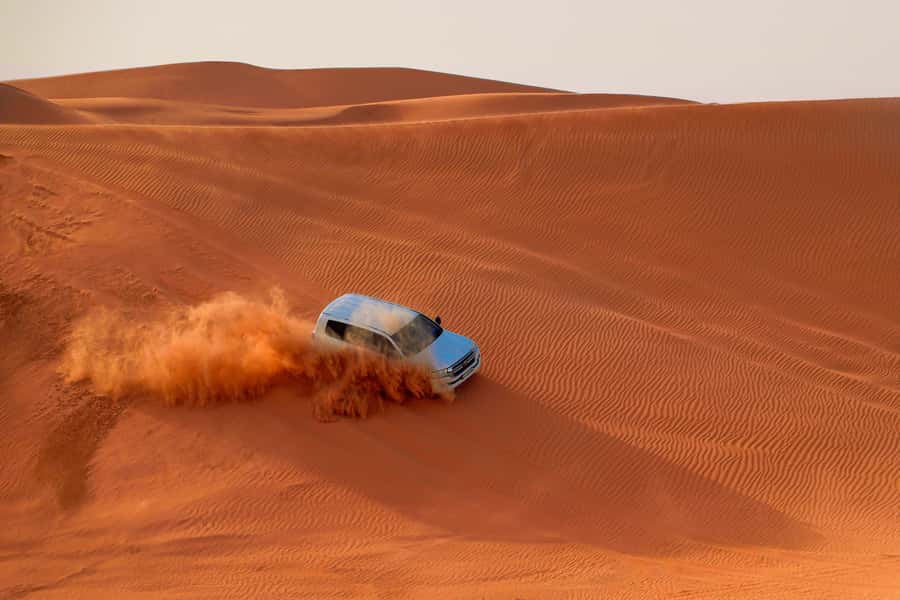 Dubai: Desert Safari, Quad Bike, Sandboarding, Camels & BBQ - From your Dubai hotel to the Lehbab red dunes