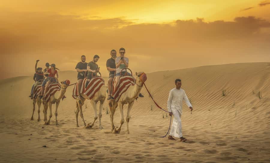 Dubai: Desert Safari, Quad Bike, Sandboarding, Camels & BBQ - Dune bashing and sandboarding on red dunes