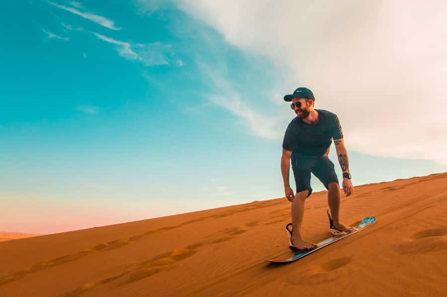 Dubai: Desert Safari, Quad Bike, Sandboarding, Camels & BBQ - Quad biking across the open sand