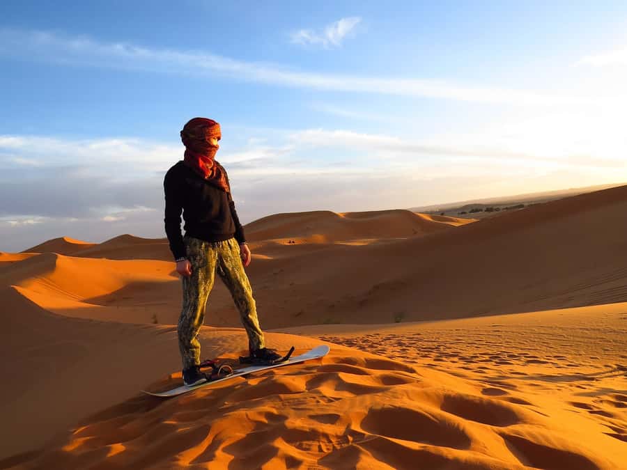 Dubai: Evening Tour with Quad Biking, Camel Ride, and BBQ - Sandboarding on a single soft slope