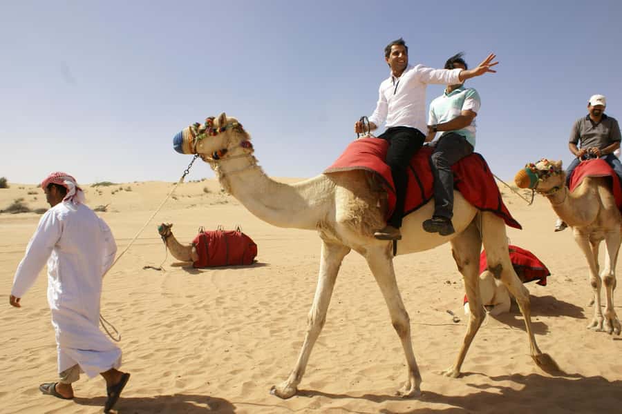 Dubai: Evening Tour with Quad Biking, Camel Ride, and BBQ - Sunset over the red dunes