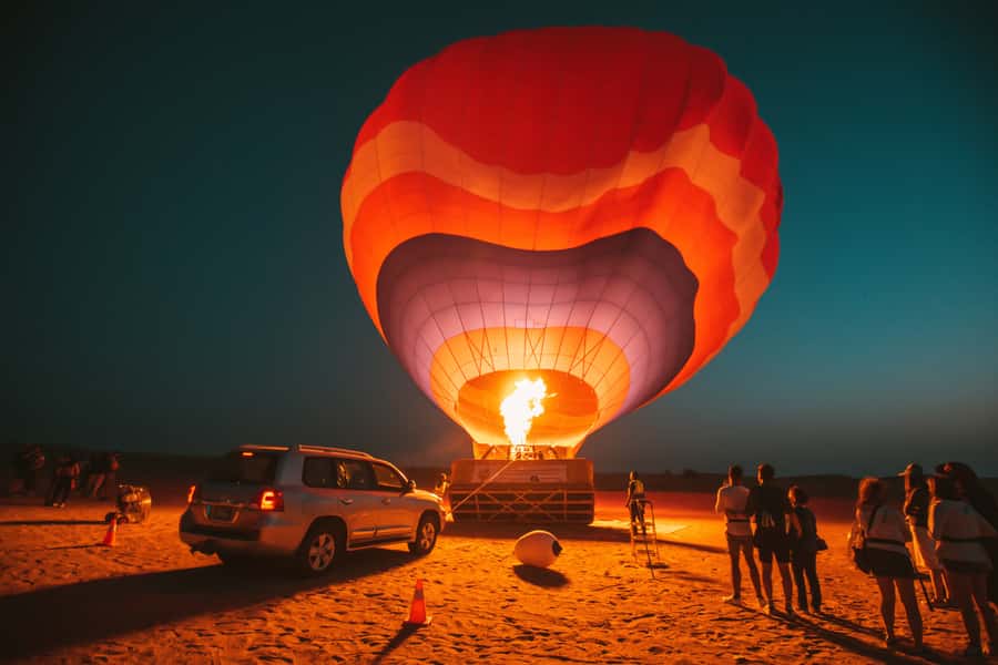 Dubai: Hot Air Balloon, Desert Safari, and Quad Biking Tour - Watching the balloon rise over the red dunes