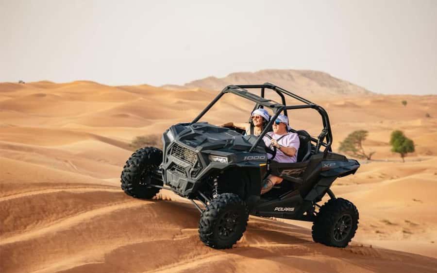Dubai: Quad Bike, Dune Buggy, and Sandboarding Experience - Reaching the red dunes from the meeting point