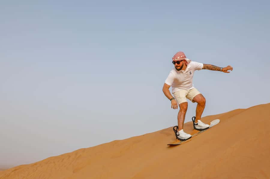 Dubai: Red Dunes Quad Bike with Sandboarding, Camels and BBQ - Quad biking across Lahbab’s red dunes