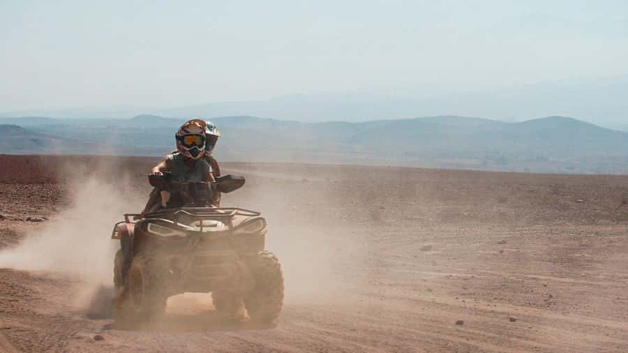 Marrakech Desert Sunset: Quad Biking, Dinner & Fire Show - Moroccan dinner under the evening sky
